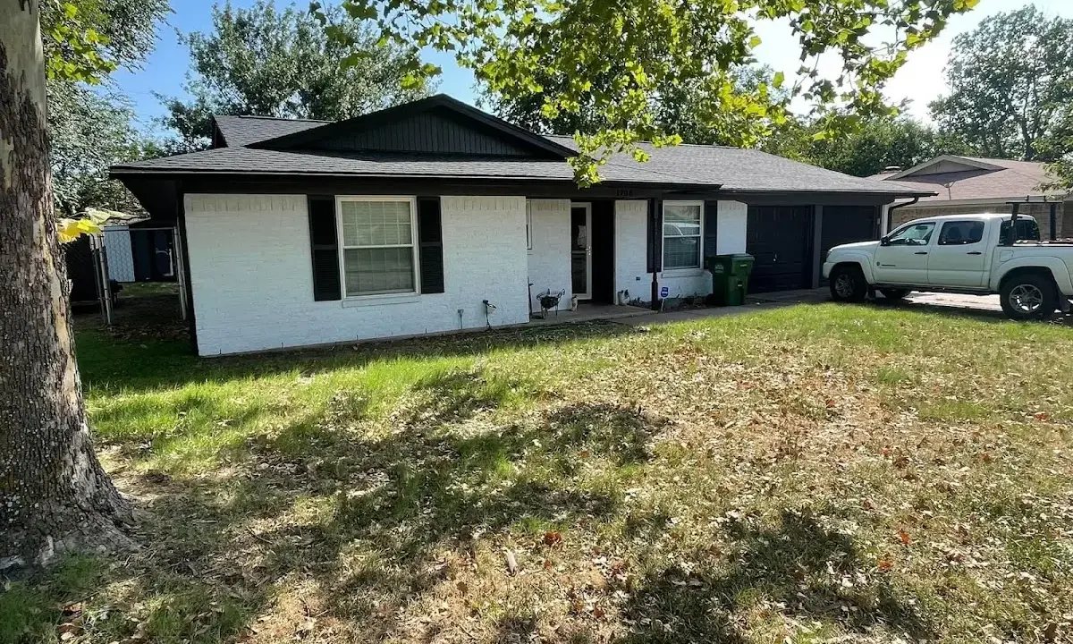Professional roofing crew working on a residential roof in Knik-Fairview